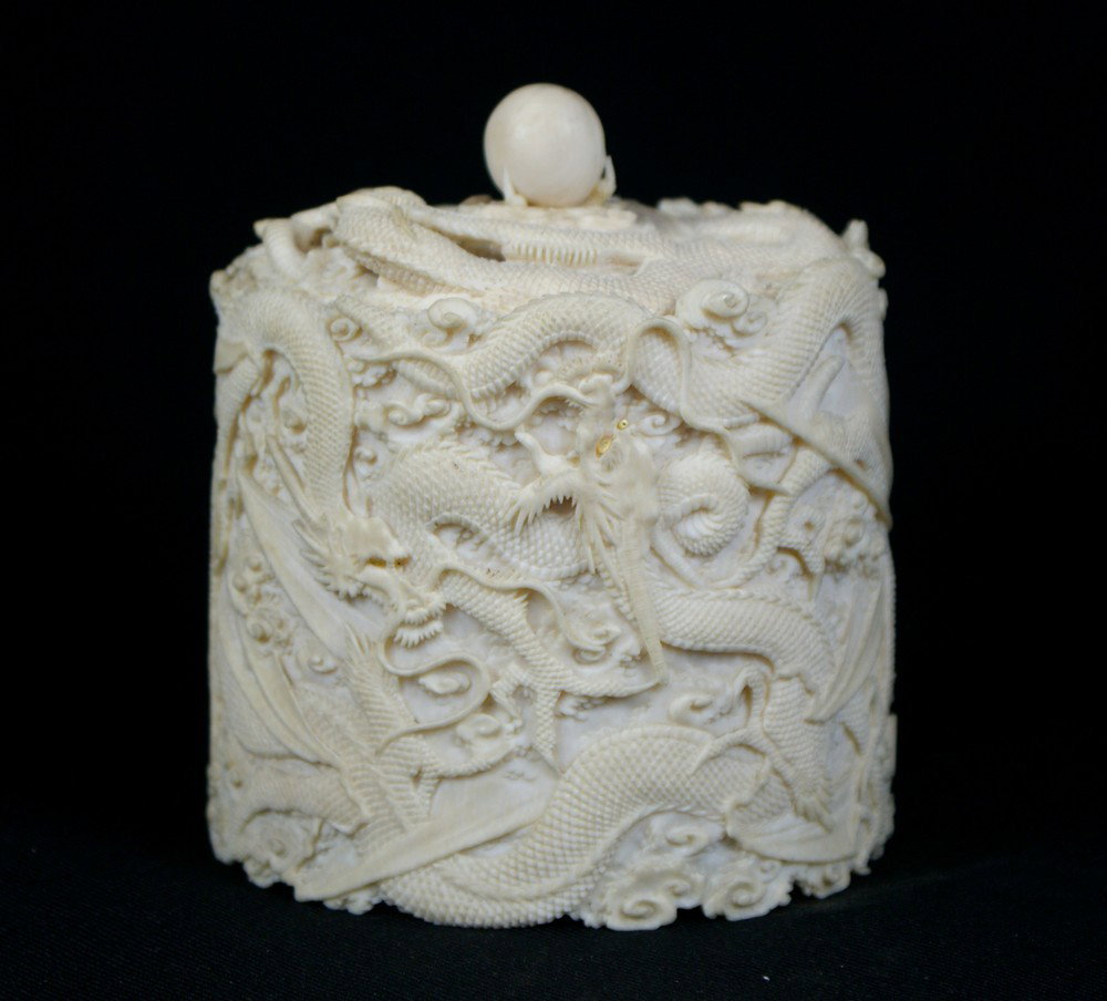 Japanese Carved Ivory Dragon Box, the dragons eye: Japanese Carved Ivory Dragon Box, the dragons eyes inlaid with mother of pearl and has a flaming pearl finial gripped by dragons talons, signature to side, circa 1875, approx 4-1/2" high, sold subject