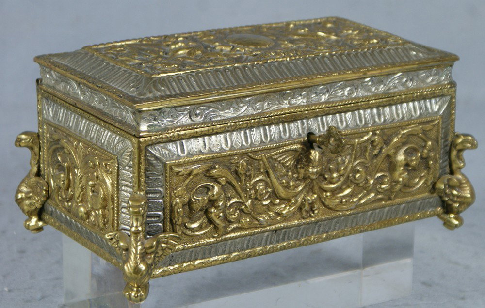 Cast bronze dresser box with winged griffins in l: Cast bronze dresser box with winged griffins on lid design and legs, velvet lined interior, 9" w, 5: d, bottom pushed thru a bit