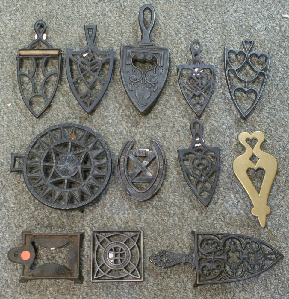 12 assorted trivets, 1 brass, various shapes: 12 assorted trivets, 1 brass, various shapes