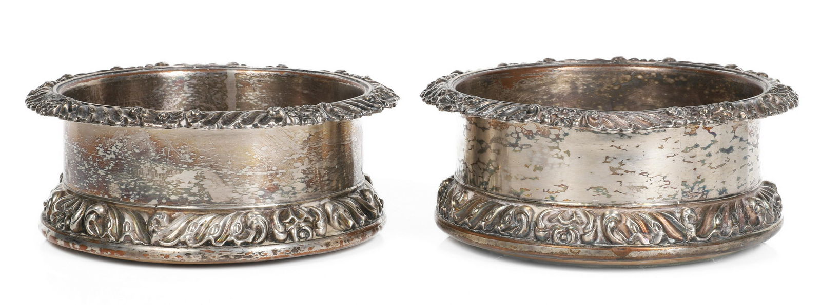 A Pair Sheffield Plate Wine Coasters, 19th C.: A pair of 19th century century wine coasters of Sheffield plate, with wooden bottoms and a silver disc at the center of each bottom bearing an engraved crest of a lion rampant with head facing dexter.