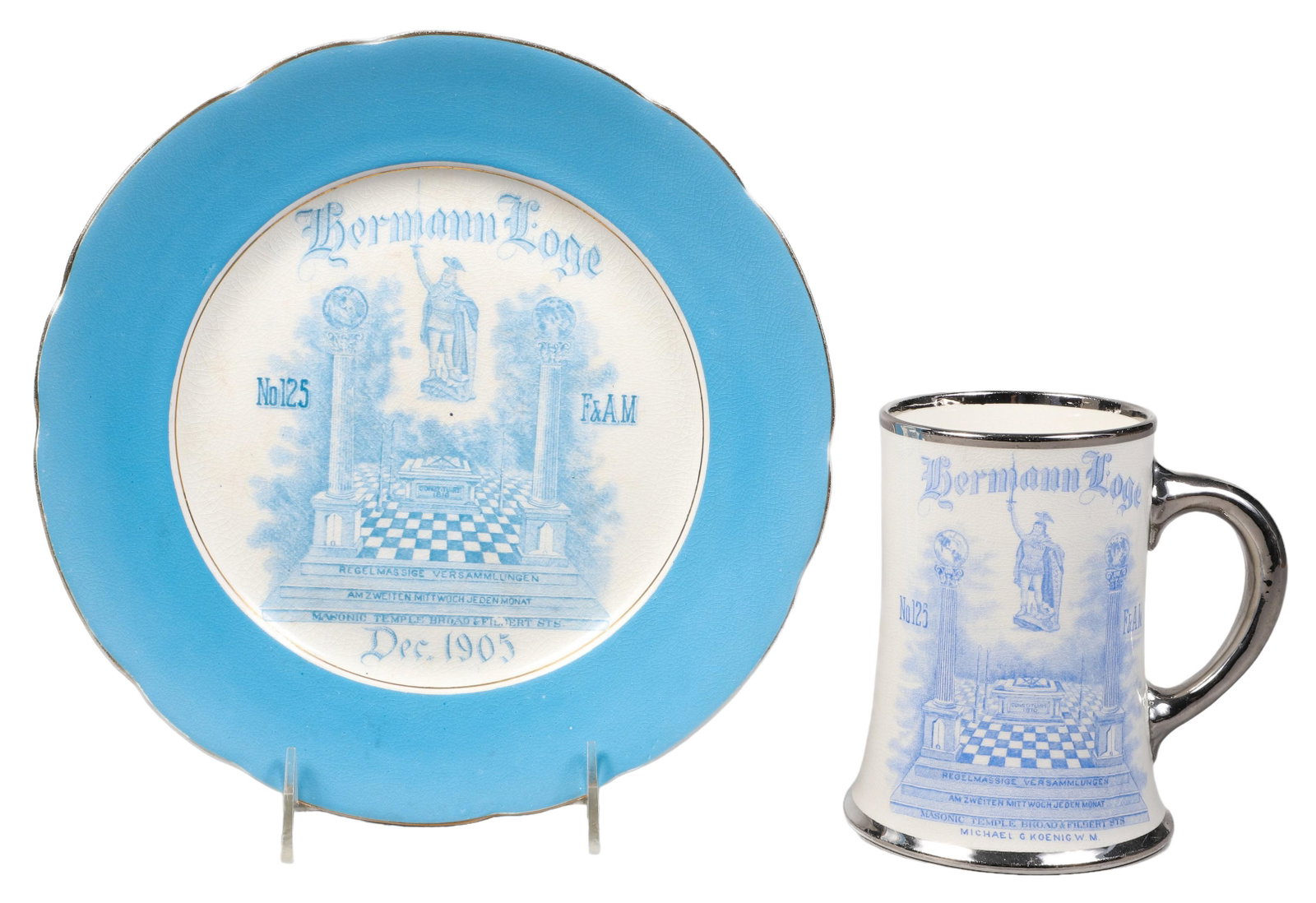 (2) Hermann Lodge Masonic Stein and Plate: (2) Hermann Lodge masonic stein and plate, Masonic Temple Broad and Filbert Street, headquarters of the Grand Lodge of Pennsylvania, Free and Accepted Masons, 9-3/4" dia plate, 5-1/4"H stein, losses t