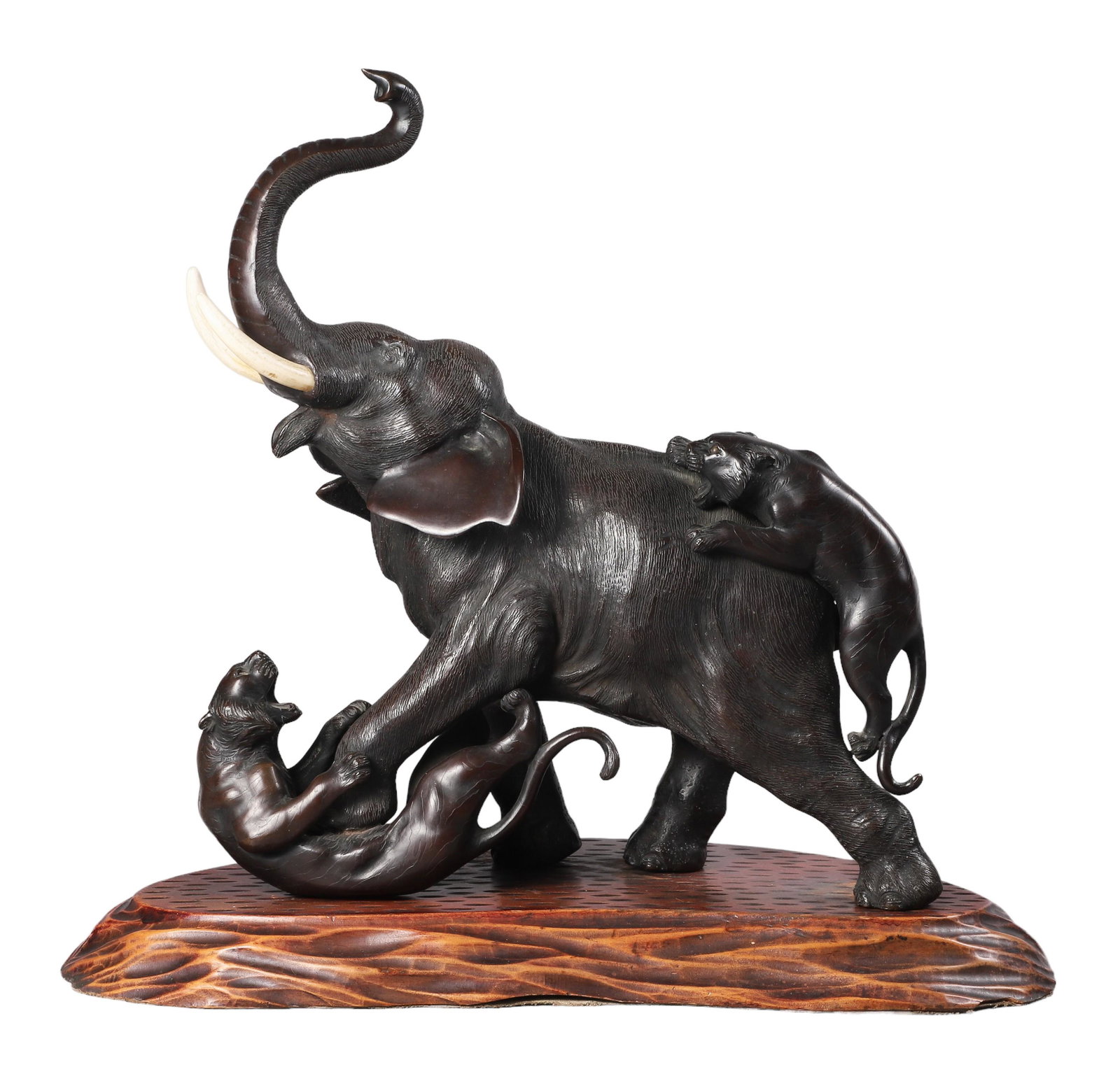 Chinese Bronze Elephant and Tiger Figure Group: Chinese bronze elephant and tiger figure group, a large textured elephant, front foot pinning a tiger to the ground as another attempts to climb his back, his trunk in the air, mouth open, with tusks 