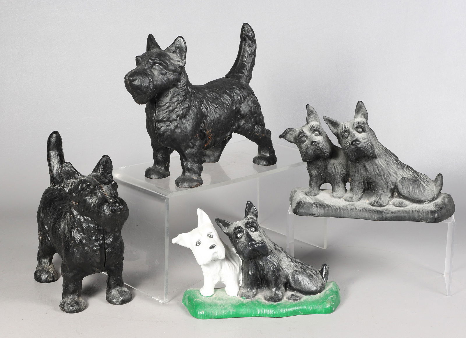 (4) Scottie Dog Cast Iron Doorstops: (4) Scottish Terrier (Scotty) dog cast iron doorstops, tallest 8-1/2"