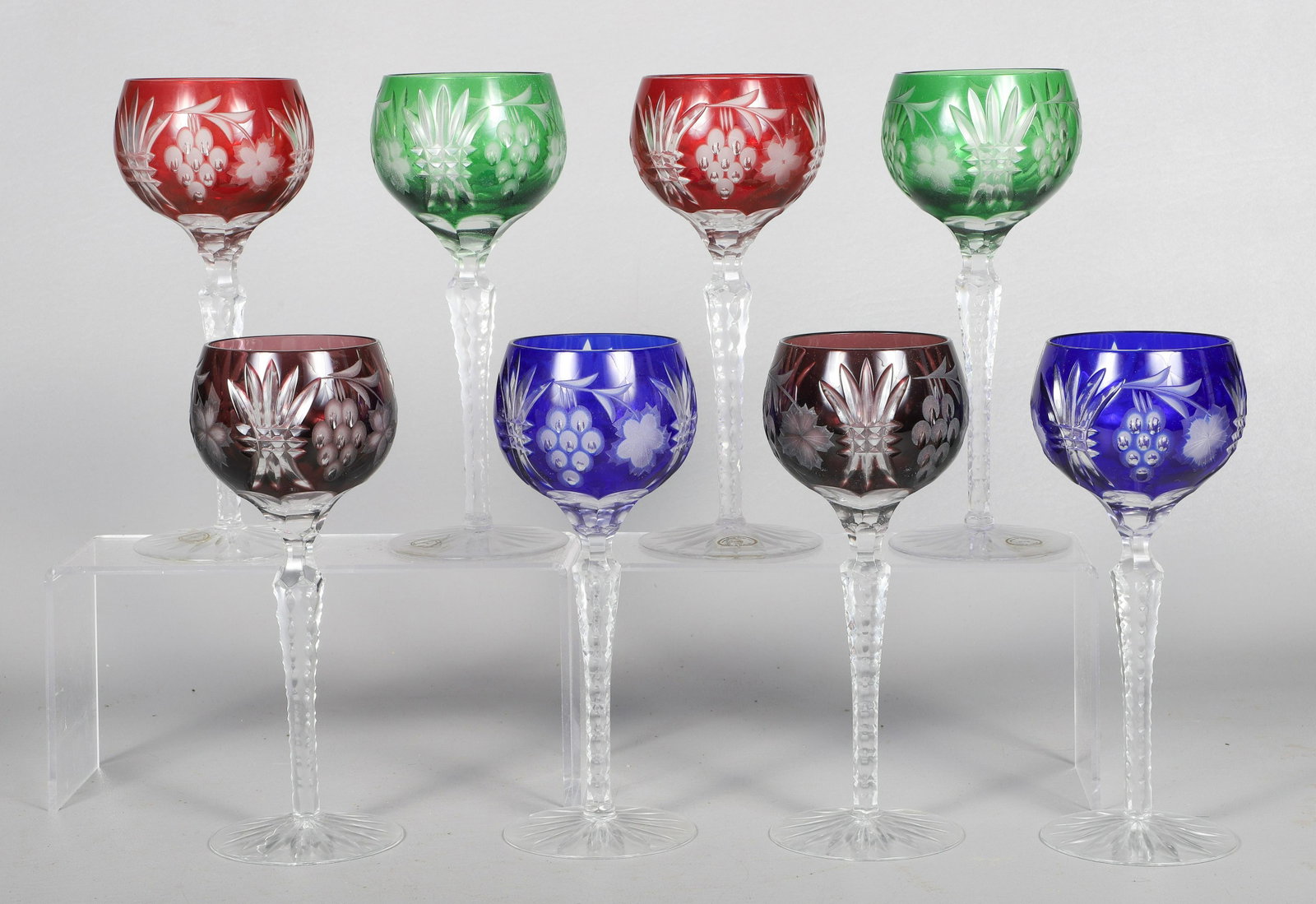 (8) Color Cut to Clear Glass Wine Goblets: (8) Color cut to clear glass balloon wine glasses, 24% lead, made in Hungary, 8-3/8" h, c/o (2) each cobalt blue, green, amethyst, ruby red, chip to base of one blue goblet