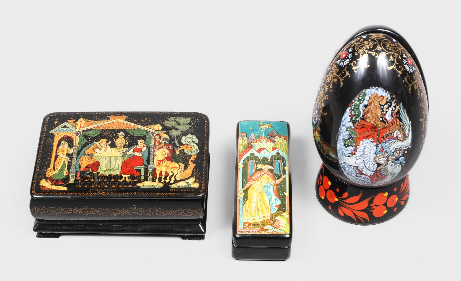 (4) Russian Items: (4) Russian items, c/o lacquer box with couple at table (3-1/2" x 2-1/2" x 1-1/2" h, overall crazing), "Tale of the Golden Cockerel" (3-3/8" x 1-1/8" x 3/4" h), lacquer egg cup (2" dia x 1" h), porcel