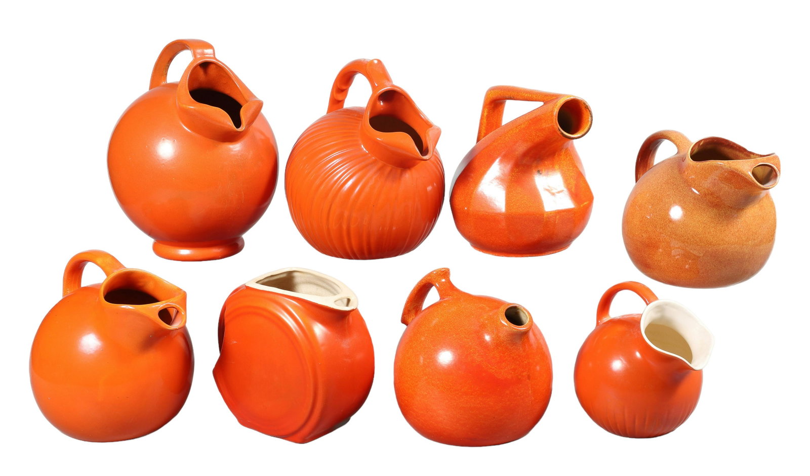 (8) Orange Pottery Pitchers: (8) Orange pottery pitchers to include RumRill, York Pfaltzgraff, Franciscan Ware with hairline to spout and unmarked, chip to base on 1