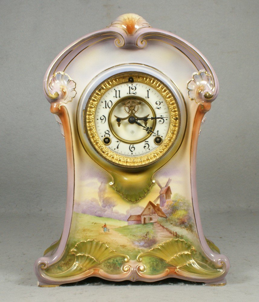 Ansonia Royal Bonn china case clock, La Meuse, 14: Ansonia Royal Bonn china case clock, La Meuse, 14" h, 2 hairlines in chapter ring, with pendulum, no key, Dimension across face 5"