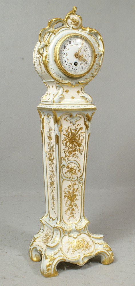 Royal Bonn porcelain case miniature tall case clo: Royal Bonn porcelain case miniature tall case clock, pale blue white raised gilt decorated ivory fields, floral decorated white enamel dial with filigree hands, back of movement marked Ch Hour, France