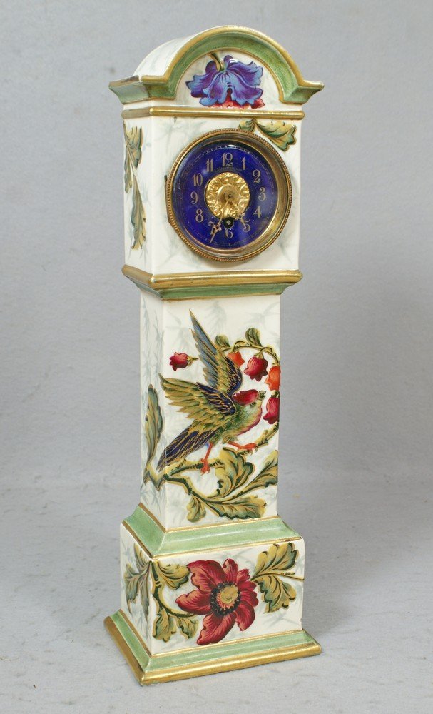Keller & Guerin, Luneville porcelain clock: Keller & Guerin, Luneville porcelain case miniature tall case clock, pale green & white case with enameled bird & floral decoration, gilt accented throughout, blue enamel dial marked JE Caldwell & Co,