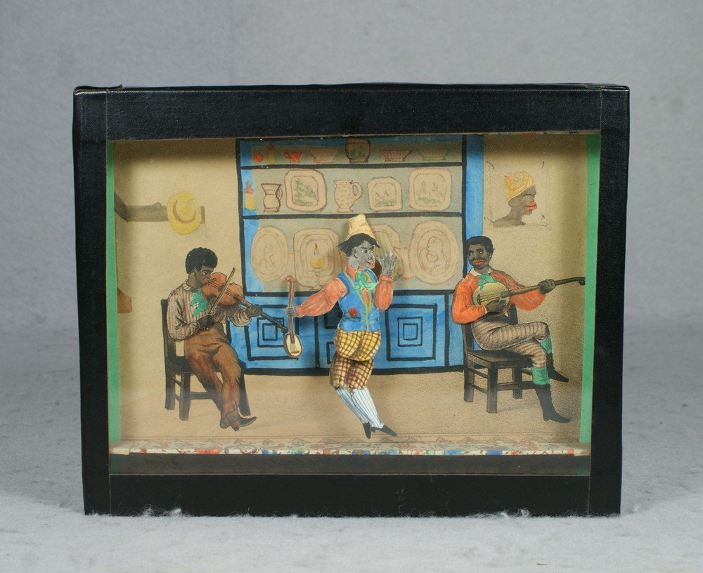 Robert Link Mechanical Box With Automaton, a sand: Robert Link Mechanical Box With Automaton, a sand toy depicting 3 black minstrels playing and the central figure dancing, it winds by rotating it counterclockwise, with original instruction label vers