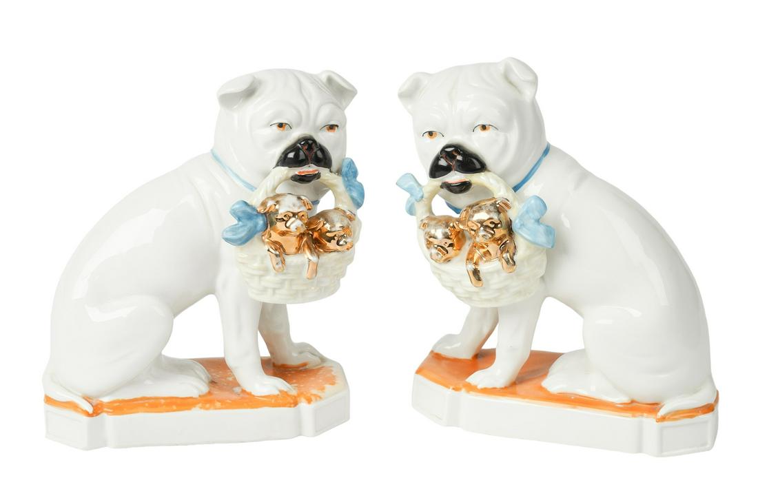 Staffordshire Style Pug Pair: Staffordshire style pug pair, seated pottery pug pair with basket at mouth containing gilt decorated pug puppies, blue painted bow accents, on cut corner bases in remnant orange, 7 3/8"H, gold missing