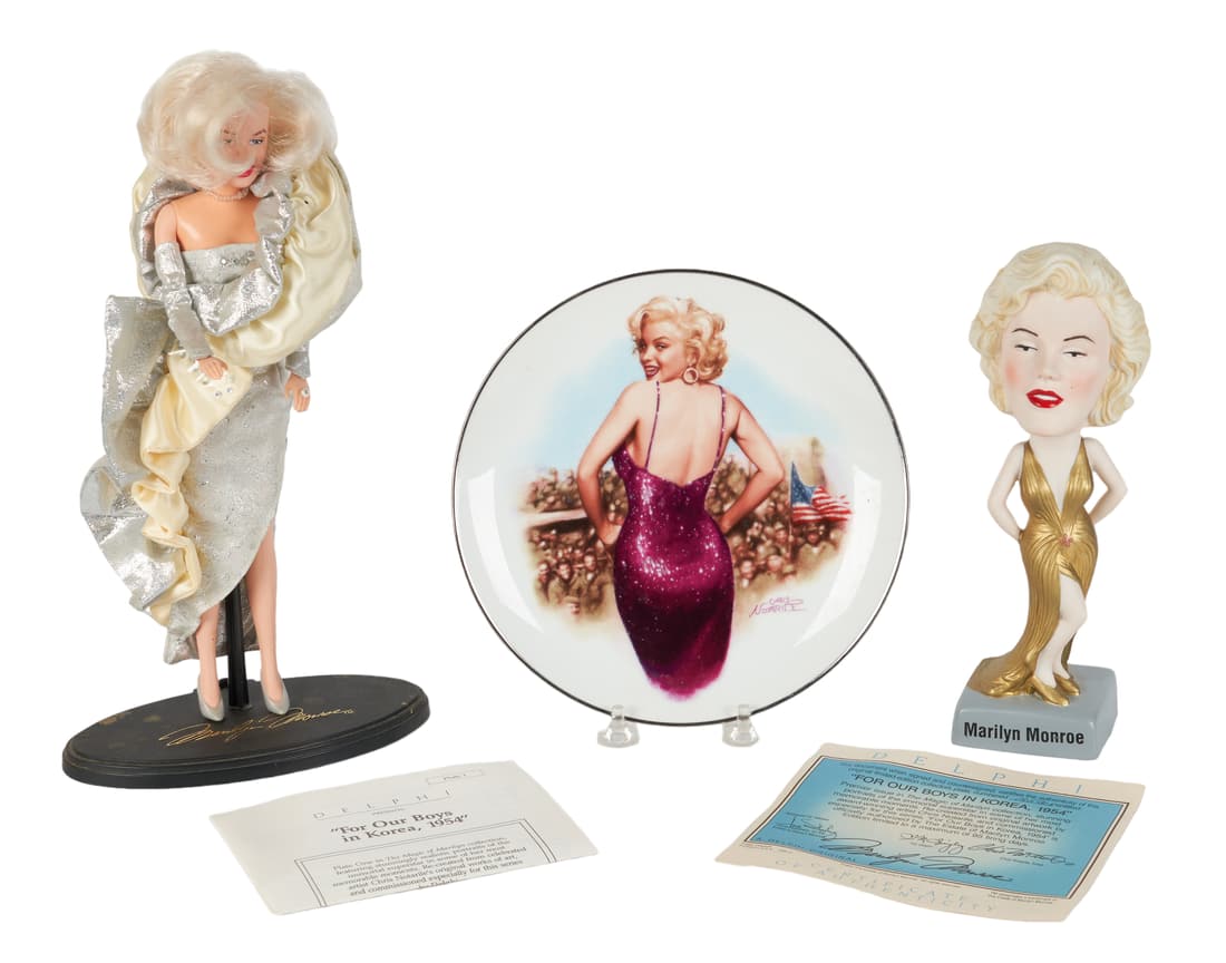 Lot of Marilyn Monroe Collector Items: Lot of Marilyn Monroe collector items, c/o 1993 DSI 12" doll in silver dress on stand, 1996 SAM porcelain 9-1/4" bobble head doll in gold dress, Delphi 1992 First Issue in "The Magic of Marilyn" colle