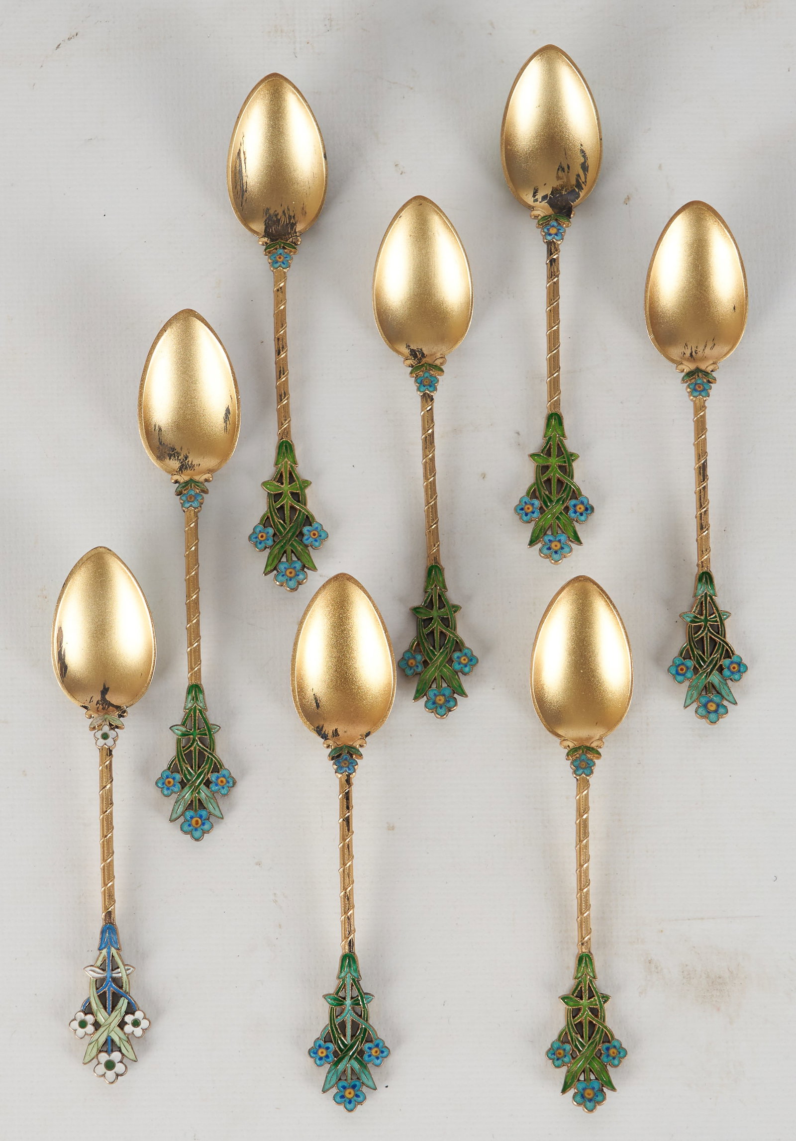 (8) J Tostrup Vermeil & Enamel Demitasse Spoons: (8) Joseph Tostrup vermeil & enamel demitasse spoons, reticulated floral handle, guilloche back of bowl, marked "JT 950S", Joseph Tostrup was a Norwegian goldsmith/silversmith born in the 19th c, the 