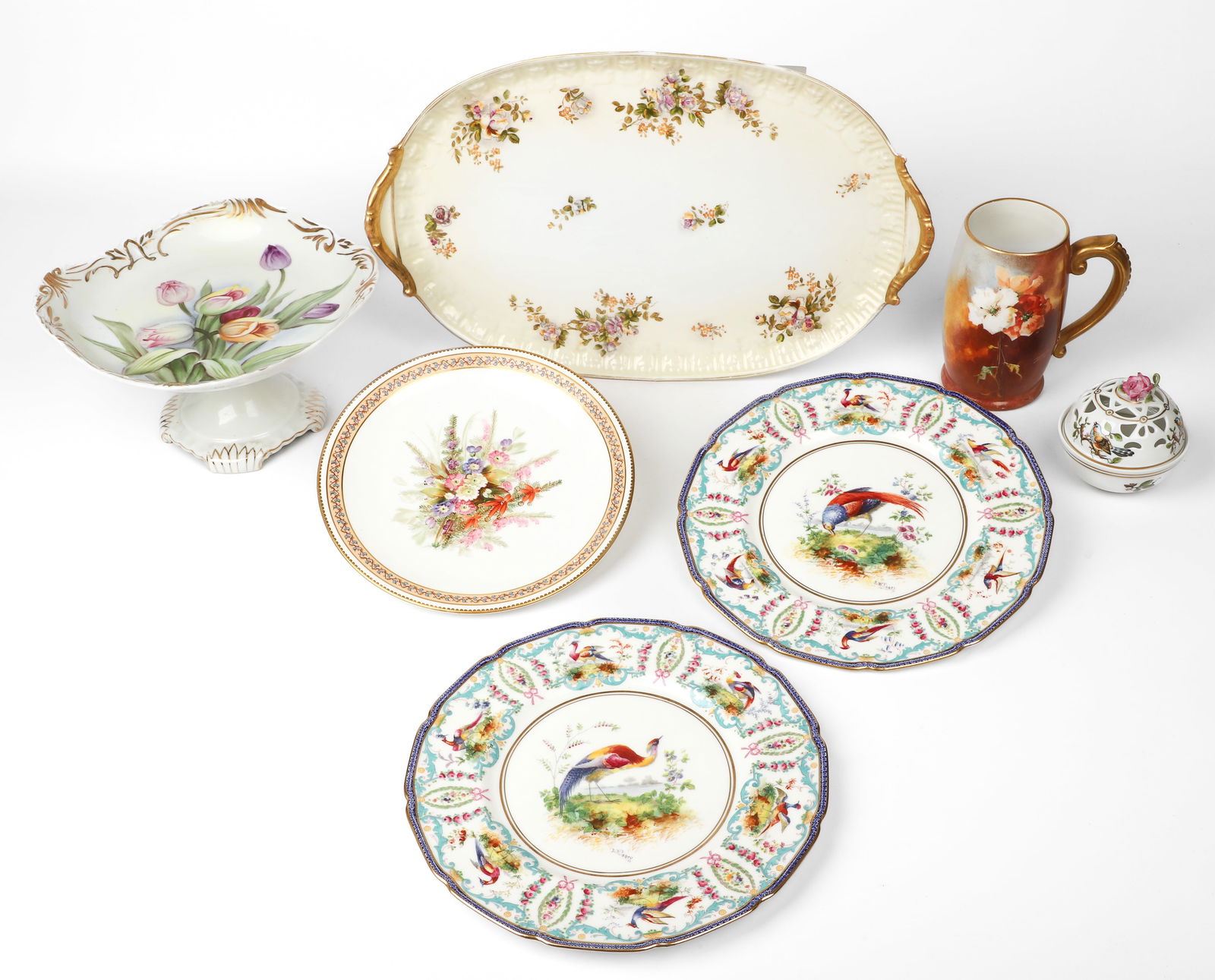 (7) Pcs Porcelain: (7) Pcs porcelain, c/o (2) Royal Doulton exotic bird plates signed EW Percy (10-1/4" dia), Hollohaza Hungary pierced bird box (3-1/2" dia x 3-3/4" h), unmarked tulip compote (9" sq x 5" h), JP Limoges