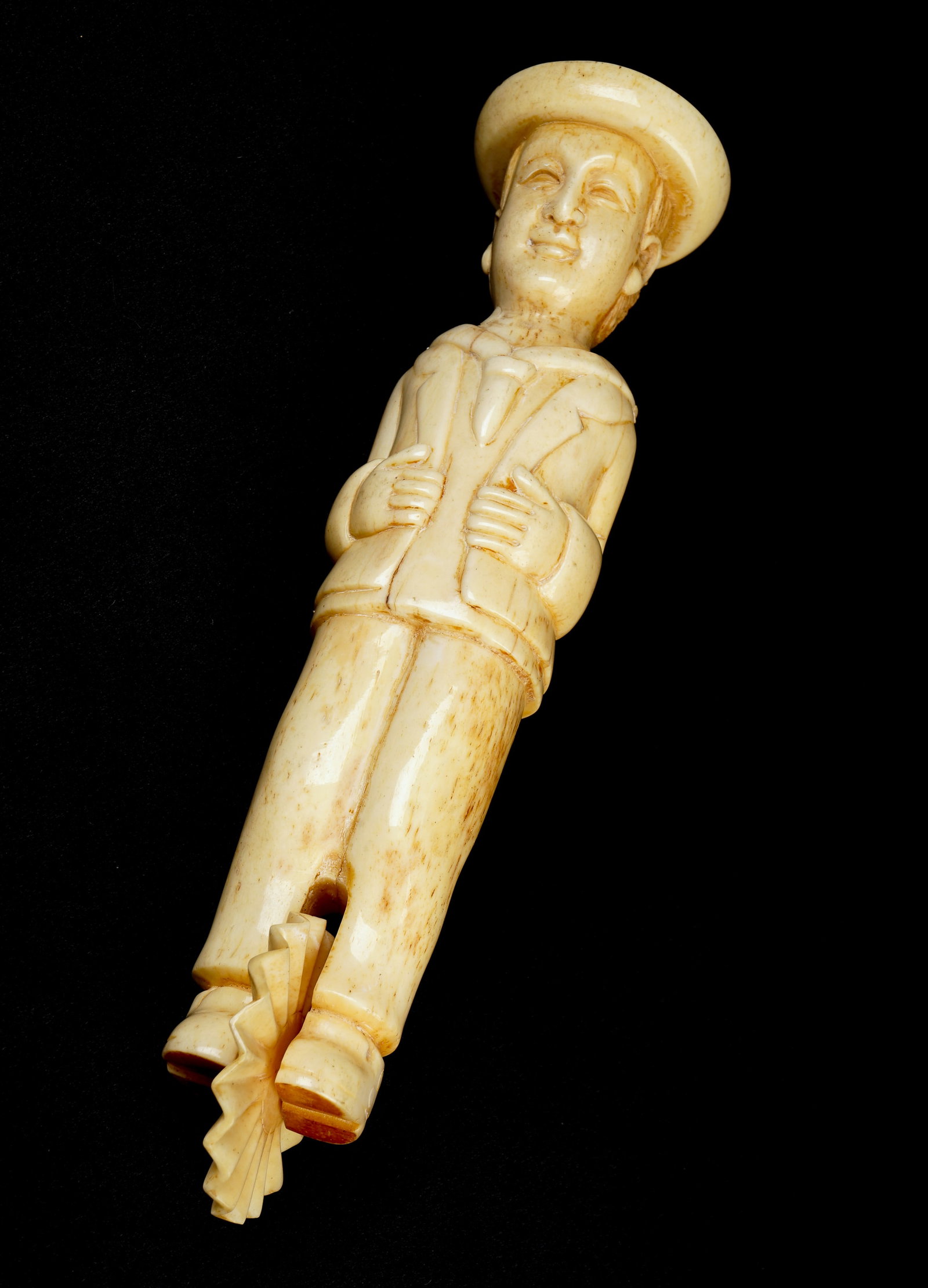 Sailor Form Carved Whale Tooth Pie Crimper: Sailor Form Carved Whale Tooth Pie Crimper, a carved figure of a sailor with boaters hat, sailors attire, his curled locks brushed back with a smiling expressive face, between his carved boots a spinn