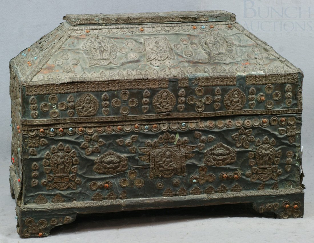 Tibetan metal covered storage chest with emboss: Tibetan metal covered storage chest with embossed brass decorations applied all over, set with various colored stones, interior also lined with metal, 21 1/2" w, 16" h, 12 1/2" d