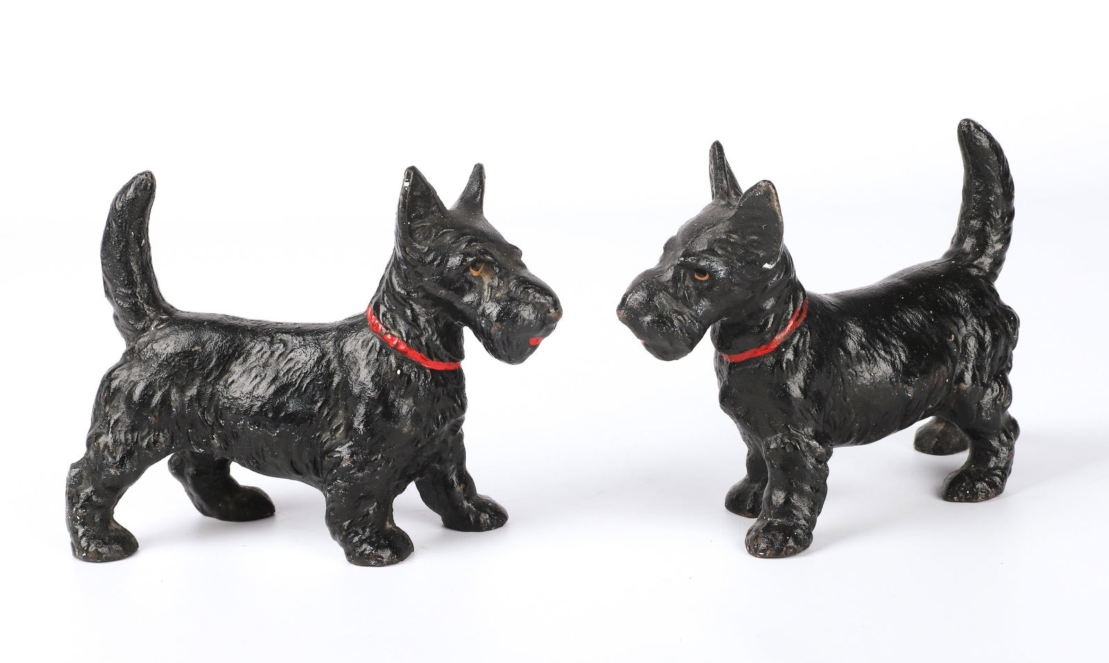 Pair of Scottie Dog Cast Iron Doorstops: Pair of Scottish Terrier Scottie dog cast iron doorstops, black painted with red collar, unmarked, possibly Hubley, 6-1/4" w x 5" h