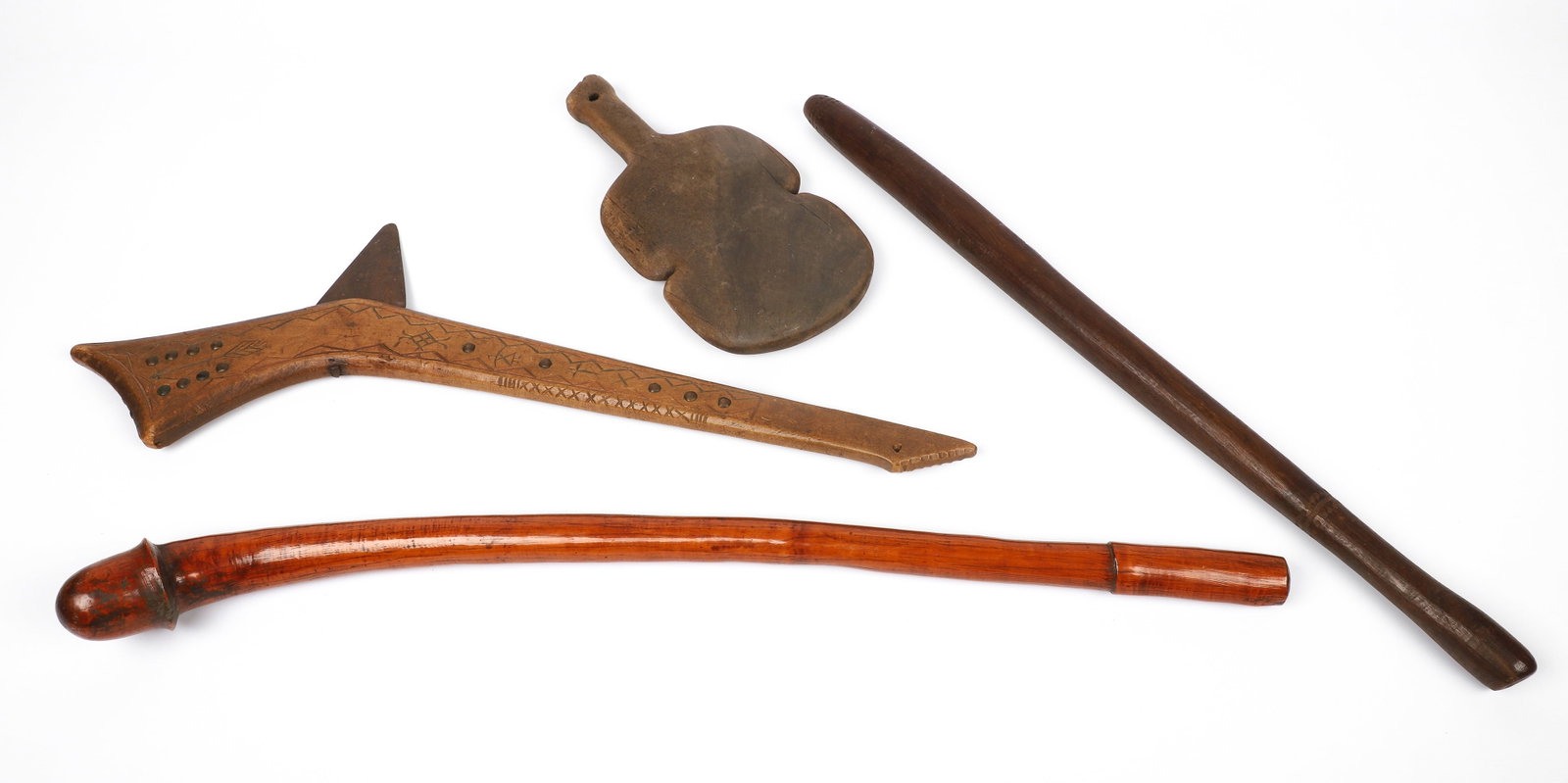 (4) War Clubs: (4) War clubs to include gun stock club with cast iron spike through haft, in engraved arrow, figure and bow decoration and rivet decoration, 25 3/4"L, a New Caledonian male phallus Kanak war club, 29