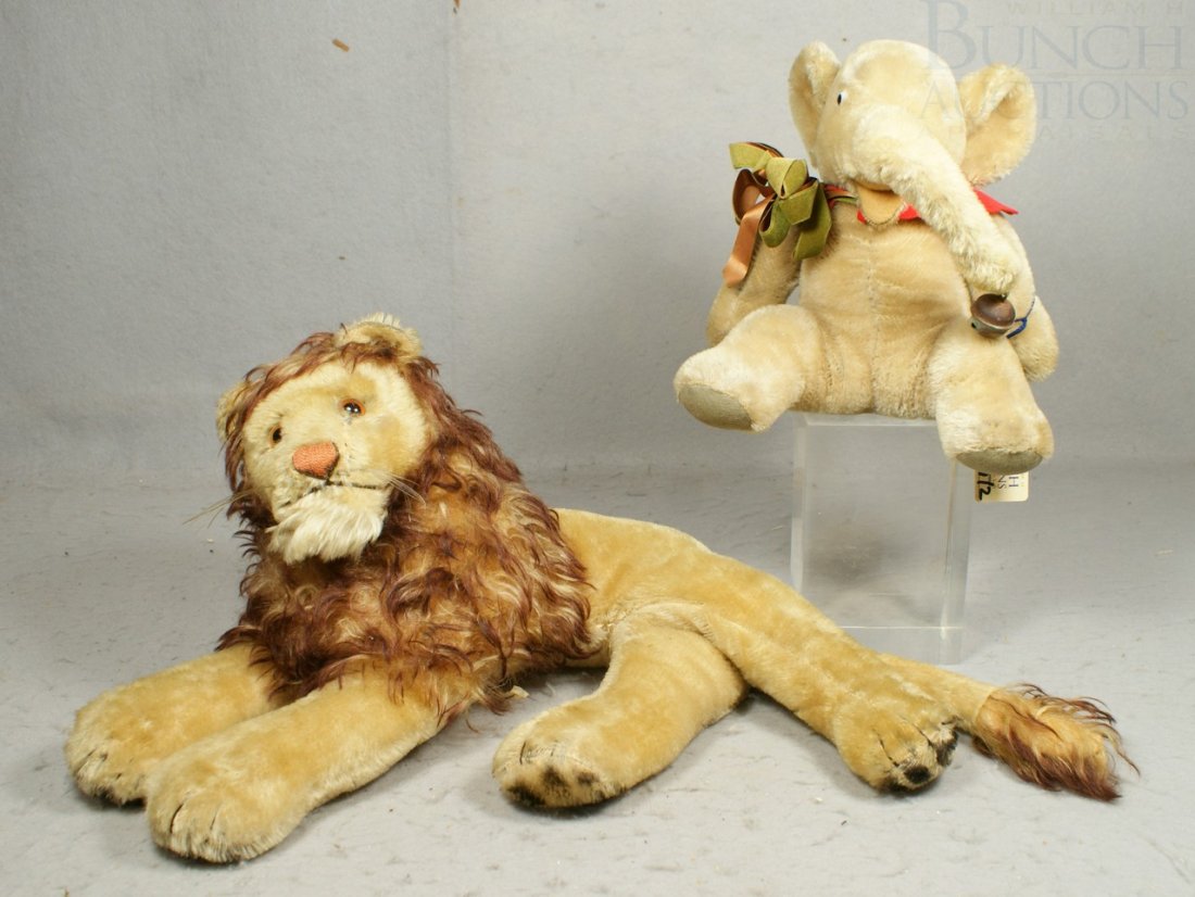 2 Steiff Animals: Steiff Mohair and Plush Recumbe: 2 Steiff Animals: Steiff Mohair and Plush Recumbent Lion (missing ear button and chest tag), some stitching coming loose at back hips, 26" long together with an elephant with jointed forearms (also mi