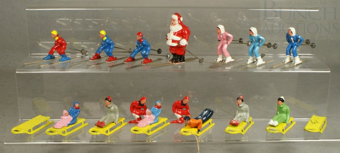 23 Barclay painted lead figurines, 7 skiers (one : 23 Barclay painted lead figurines, 7 skiers (one Santa), 8 sleds, 6 sled riders, and two fishermen, tallest 3"