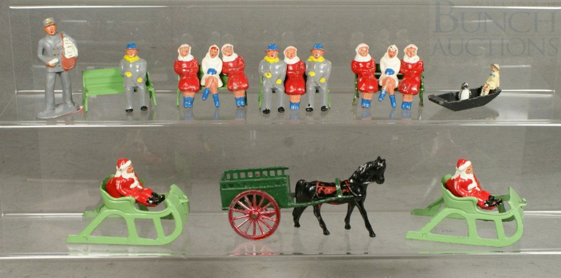 19 Barclay painted lead figures and 4 others, inc: 19 Barclay painted lead figures and 4 others, including 4 benches, 10 bench sitting figures, 1 postman, 2 sleighs, 2 sitting Santa's together with a boat, seated girl and horse and buggy (marked Made