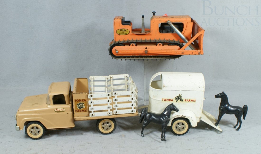 2 Pressed Steel Tonka Toys, including No. 35 Far: 2 Pressed Steel Tonka Toys, including No. 35 Farm Stake Truck and Horse Trailer Toy, with 2 horses, some paint loss, 14" L and a Giant Bulldozer, 12"