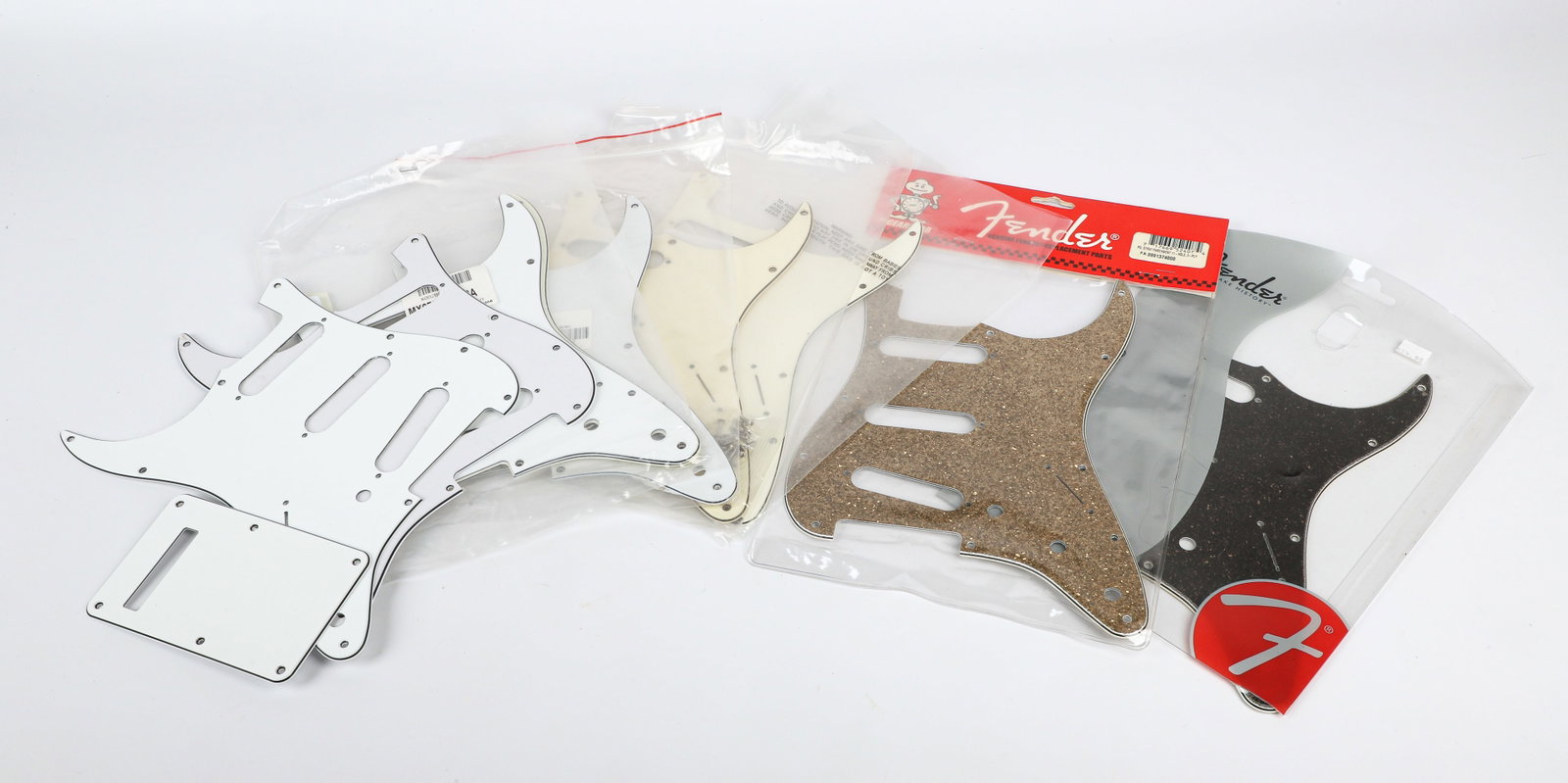 10 Assorted Fender Pic Guards and one Fender Back Plate, some unopeded in original packaging: 10 Assorted Fender Pic Guards and one Fender Back Plate, some unopeded in original packaging Like New to New