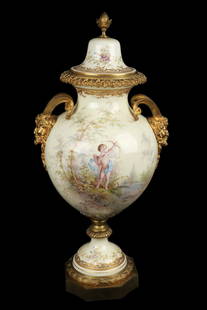 Sevres Type Bronze Mounted Porcelain Urn: Sevres type bronze mounted porcelain urn, late 19th C., of baluster form with satyr mask gilt bronze handles, painted to show a reclining maiden with cherubs in a forest, signed G. Poitevin, all again