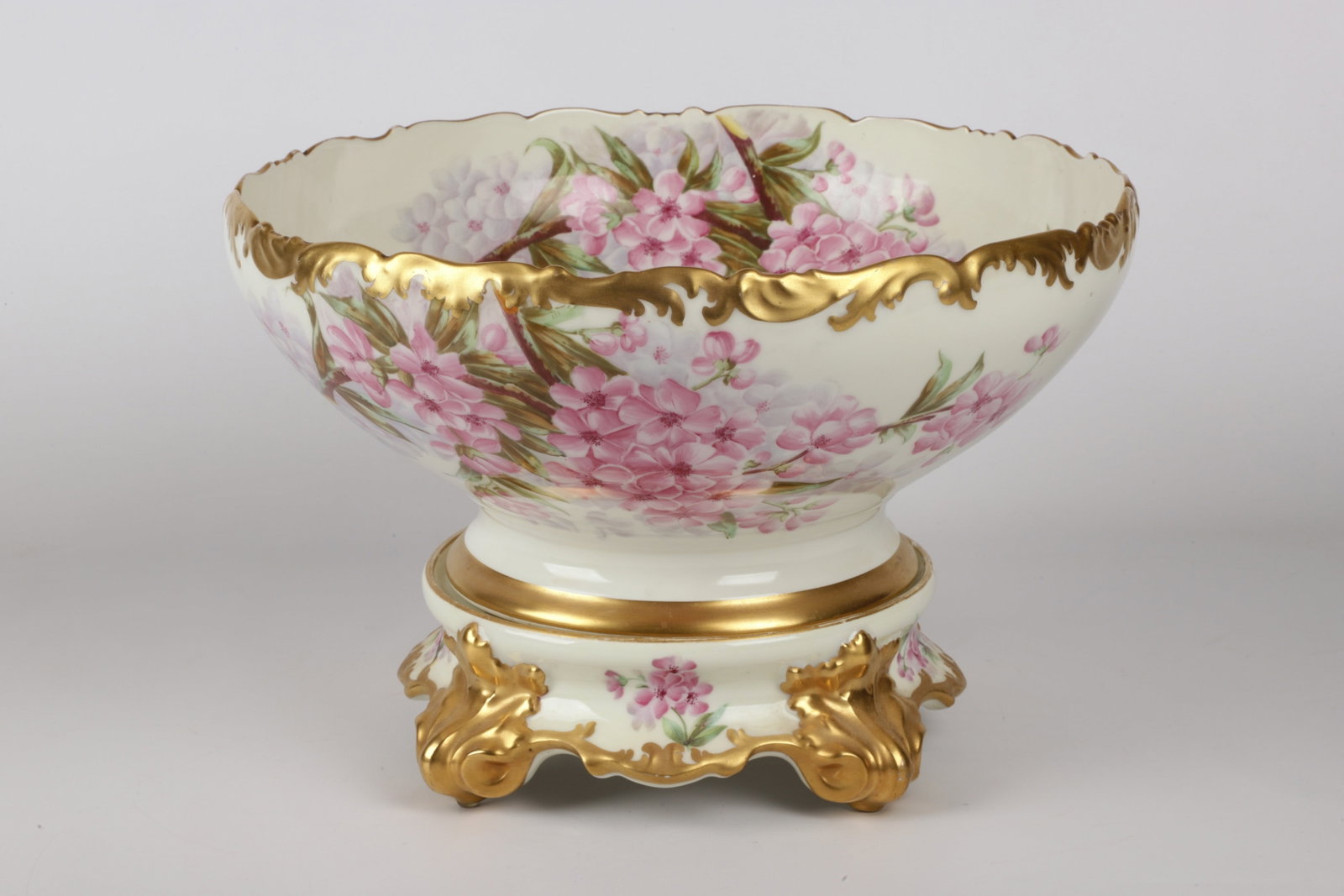 T&V Limoges Pedestal Punch Bowl on Stand: T&V Limoges Pedestal Punch Bowl on Stand, Tressemann & Vogt, hand painted 2-part porcelain punch bowl and stand, in pink and purple floral painted decoration with heavy parcel gilding at scrolled rim 