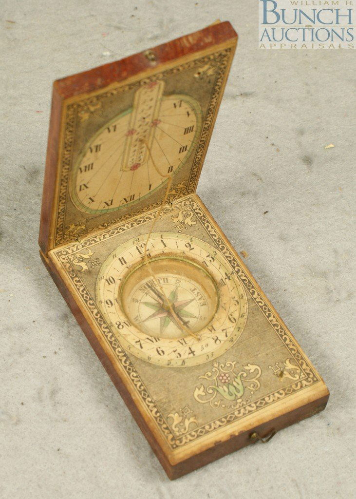 Wooden and Paper Diptych Pocket Sundial, Germany: Wooden and Paper Diptych Pocket Sundial, Germany, with latitudes of major cities printed on the lid opening to reveal a central compass with tricolored card, printed dials with Arabic & Roman numerals