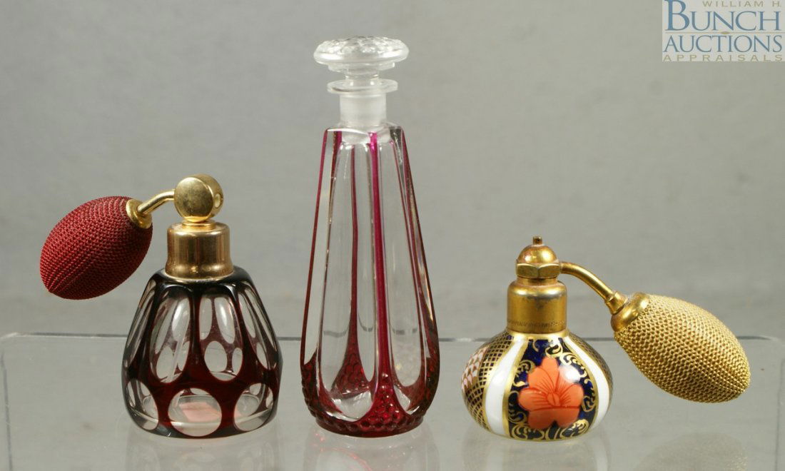 (3) perfume bottles, ruby to clear with atomizer: (3) perfume bottles, ruby to clear with atomizer, ruby flashed with ground stopper (small flakes), and a Royal Crown Derby with atomizer, tallest 5"