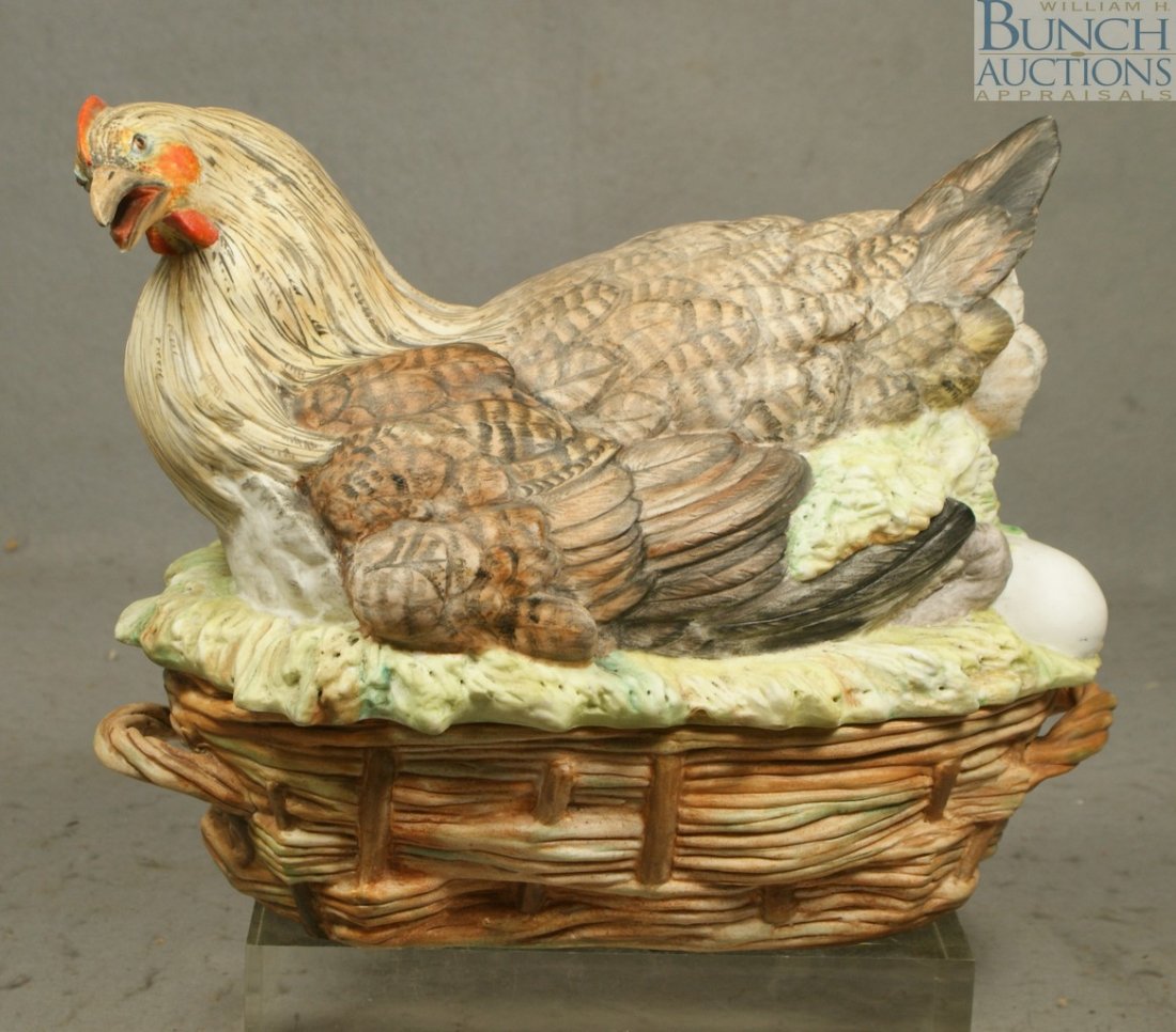 Bisque finished porcelain hen on nest, grassy ne: Bisque finished porcelain hen on nest, grassy nest with eggs, perhaps French, woven basket base with open handles, 11 3/4" l, 9 1/4" h