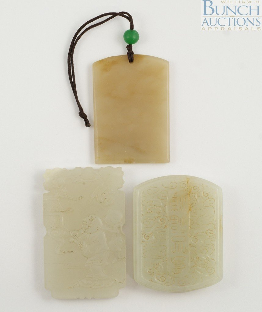 3 Chinese carved jade tablet ornaments. Boy with: 3 Chinese carved jade tablet ornaments. Boy with flute, cloud formations, and a plain one. Approximately 2 1/2"