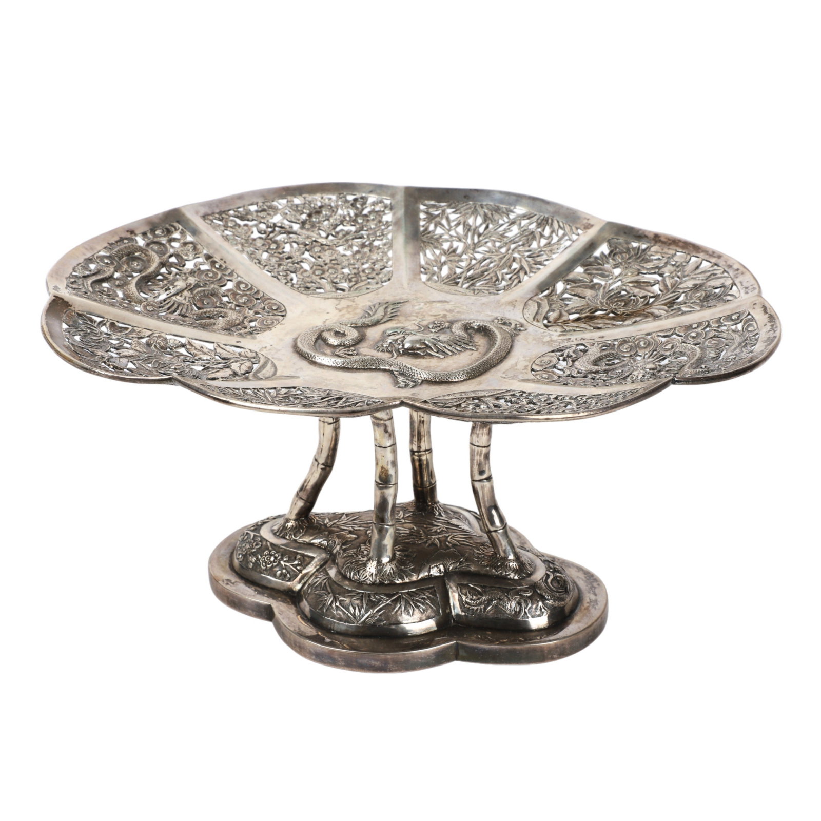 19th C Luen Hing Silver Pierced Compote: 19th C Luen Hing silver pierced compote, 1880-1925, Shanghai, a repousse dragon at center in a scalloped chrysanthemum, cloud, cherry blossom and bamboo surround, raised on bamboo form supports over l