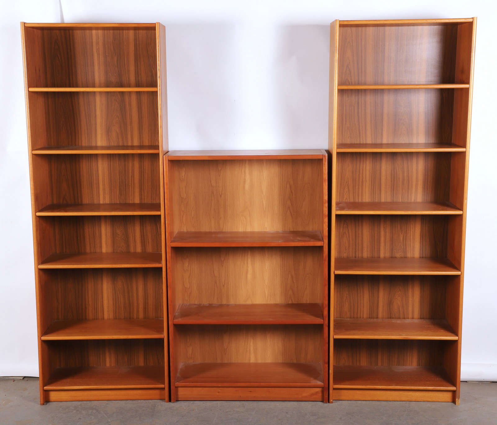 Lot of (3) Danish modern bookcases: Lot of (3) Danish modern bookcases, (2) - (5) shelf and (1) - (2) shelf bookcases, (2) -72"H x 25"W x 11"D, (1) - 48"H x 31"W x 12"D