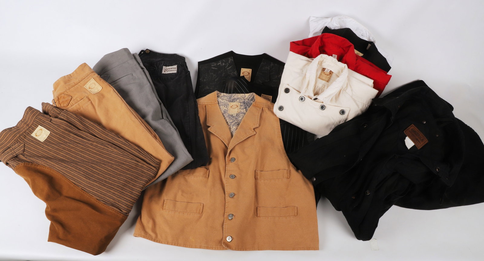 A collection of Wah Frontier Clothing and style: A collection of Wah Frontier Clothing and style to include an Outback Trading Co. oilcloth cotton trench, L, Wah Maker frontier clothing trousers and vest, size 40 trousers, XL vest, Frontier Classics
