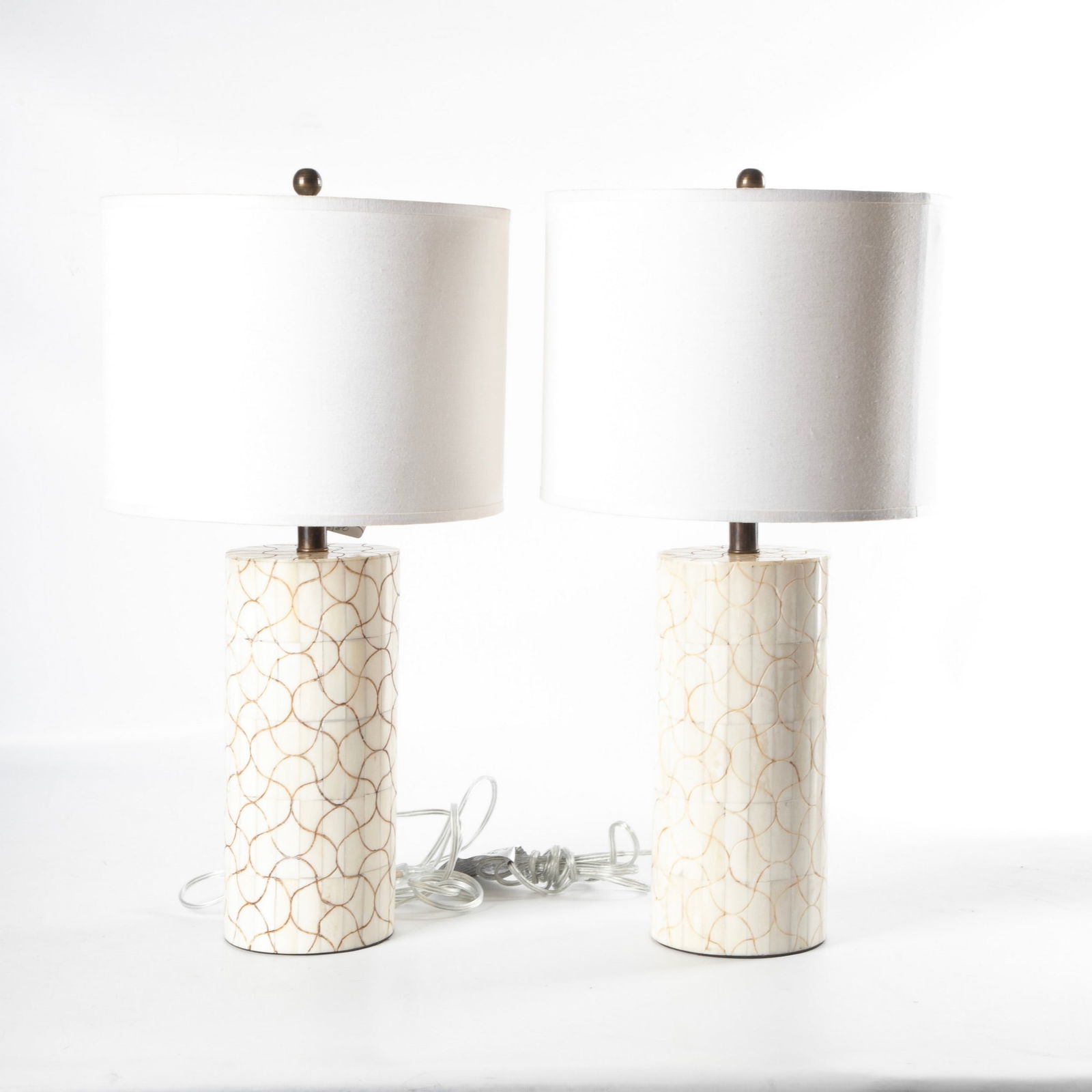 Geometric bone tiled cylinder table lamp pair: Geometric bone tiled cylinder table lamp pair, in engraved abstract patterned decoration, each with coordinating linen shade, 24 1/2"H to top of shade.