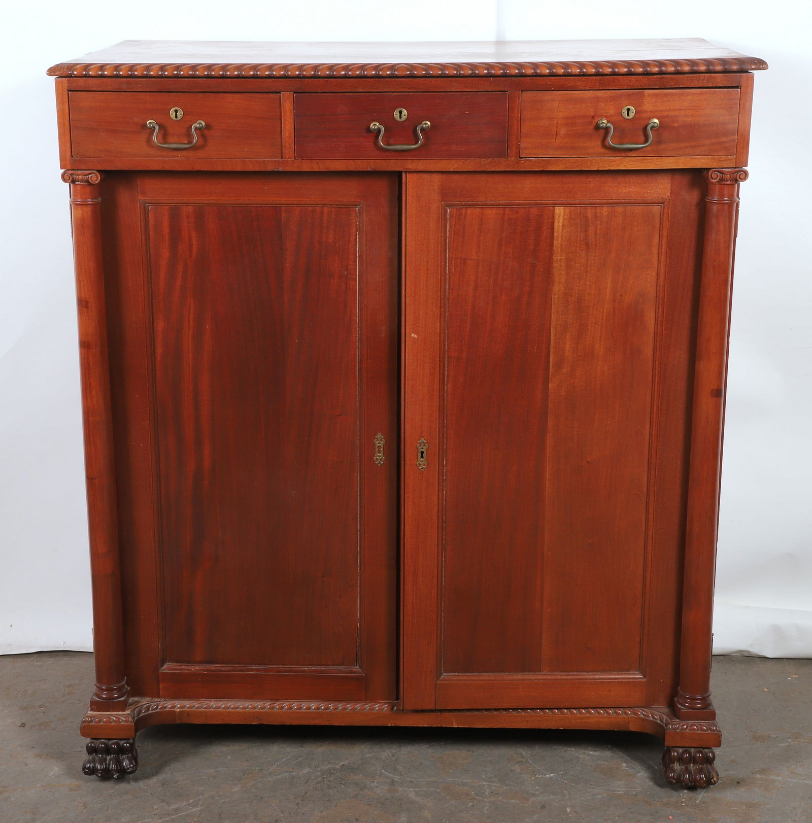 Mahogany man's chest: Mahogany man's chest, gadrooned edge top, top is warped and in (2) pieces, needs repair and attaching, over (2) column adorned chamfered panel doors concealing, (3) short linen press drawers, center s