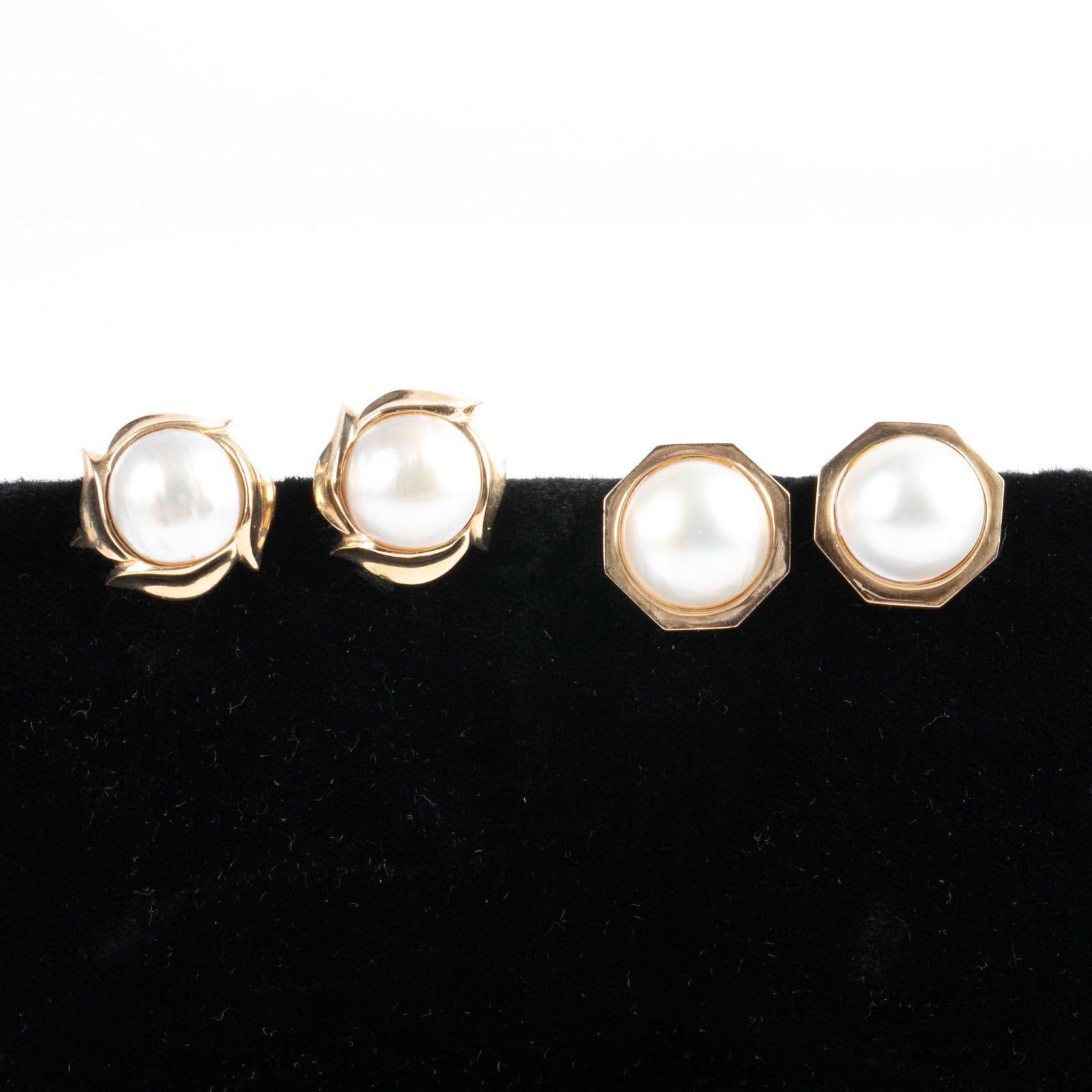 (2) Pairs 14K Yellow Gold Mabe Pearl Earrings: (2) Pairs 14K yellow gold mabe pearl earrings to include 13 mm dia pearl centered earrings in petal surround, 3/4" dia, along with similarly designed octagonal 3/4", 14.1 DWT