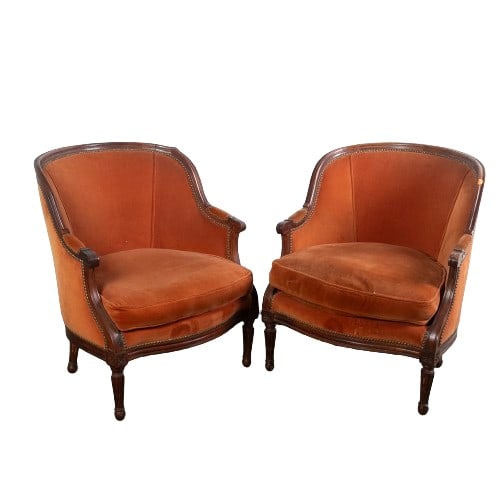 Pair Louis XVI style upholstered lounge chairs: Pair Louis XVI style upholstered lounge chairs, carved walnut frame, orange tacked upholstery, rosettes over tapered reeded legs, 35"h x 29-1/2"w x 26"d, wear to upholstery