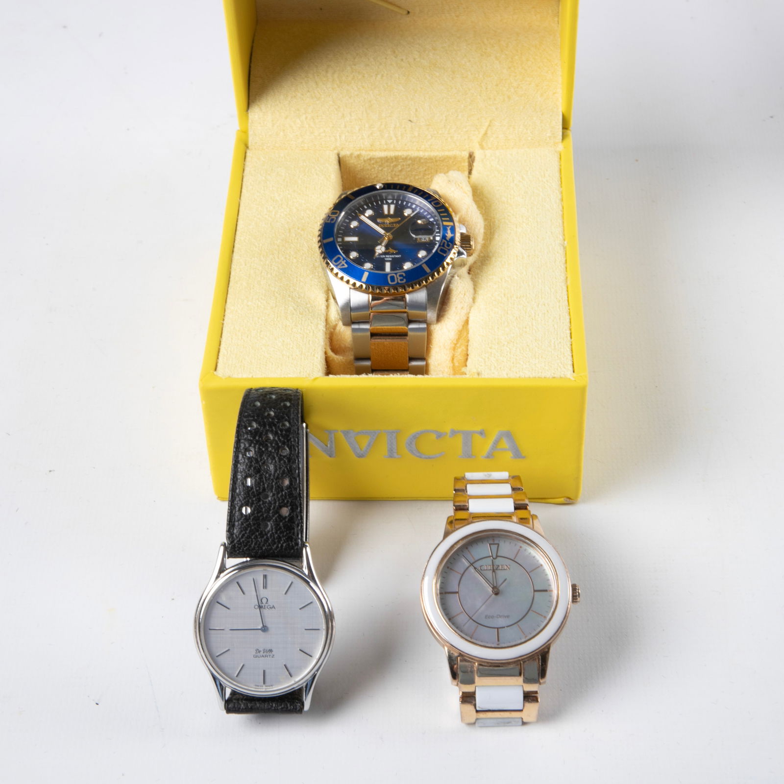 (2) Citizen, Omega and Invicta Wristwatches: (2) Citizen, Omega and Invicta Wristwatches to include a ladies Citizen 'Chandler' ceramic watch, MOP face, eco-drive technology, light powered, 36 mm, (2) links included, an Omega DeVille quartz wris