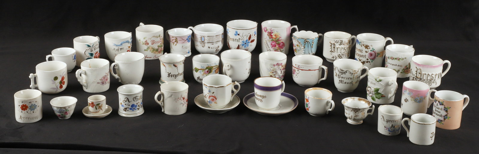 (35+) Porcelain motto cups: (35+) Porcelain motto cups, including "Forget Me Not", "Present", "Love the Giver", "For a Good Girl", "A Gift", "Be Always Happy", and more