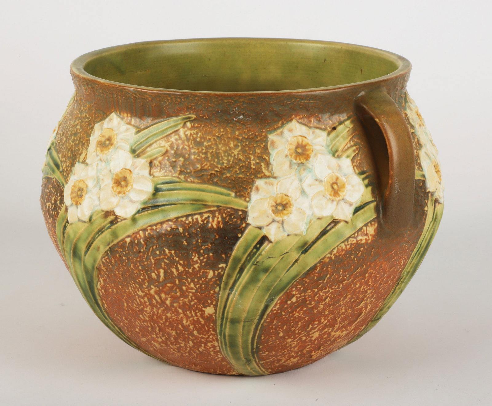 Unmarked Roseville Jonquil jardiniere: Unmarked Roseville pottery Jonquil jardiniere, white blossom flowers bas-relief with a brown textured body and lug handles, 13" dia x 10" h