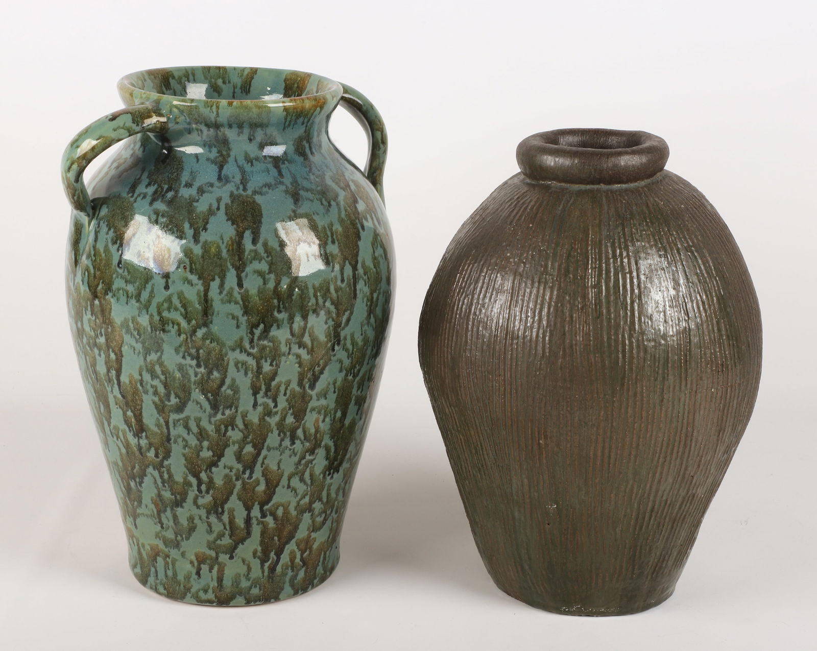 (2) Large pottery vases: (2) Large pottery vases, including unmarked textured redware jar (15" h), unmarked vulcan glazed double handled vase (16-1/2" h)