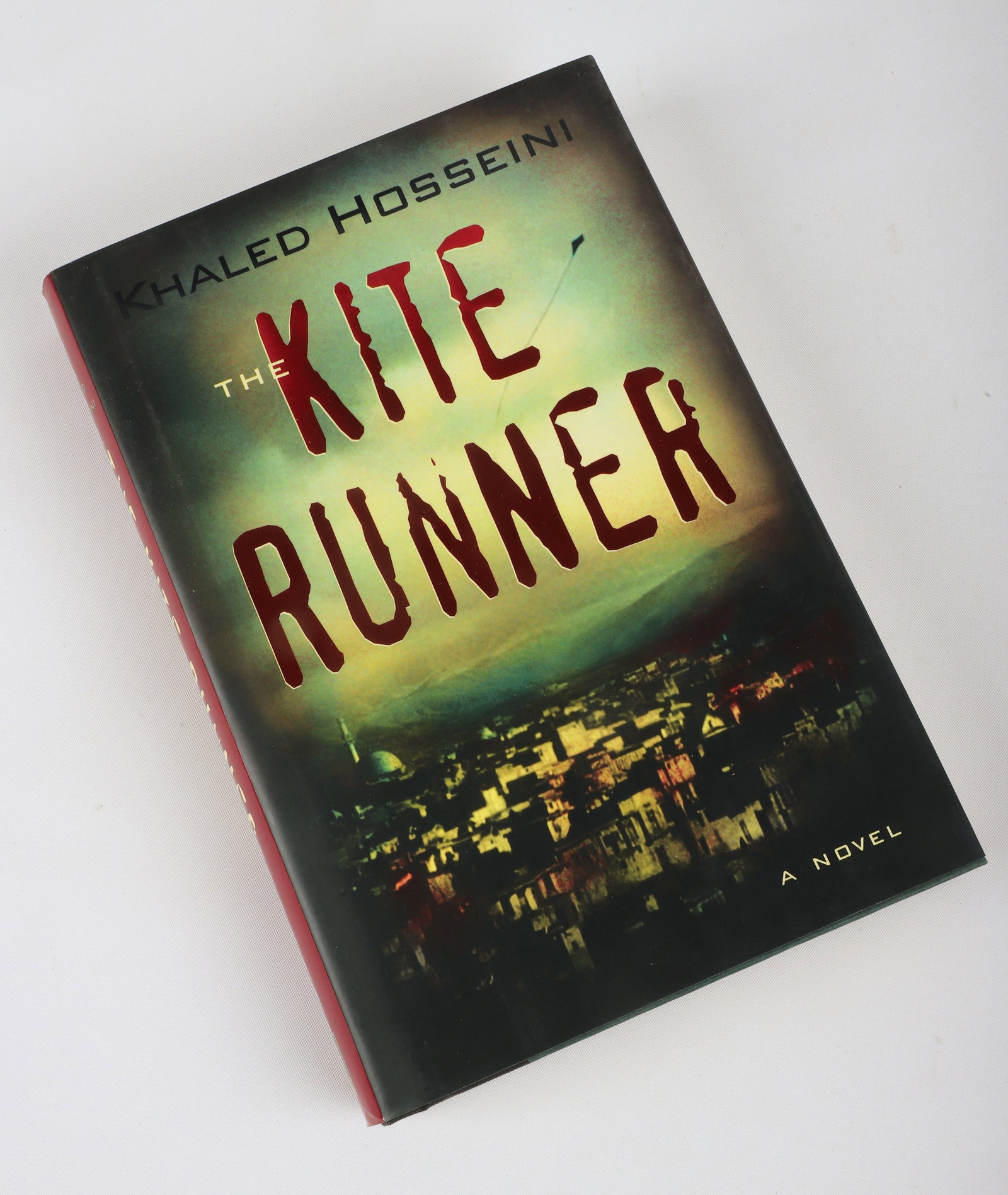 The Kite Runner by Khaled Hosseini (signed): An early printing of The Kite Runner by Khaled Hosseini (New York, 2003), signed by Hosseini in English and Farsi on the title page. This was the basis for the 2007 film of the same name. This copy is