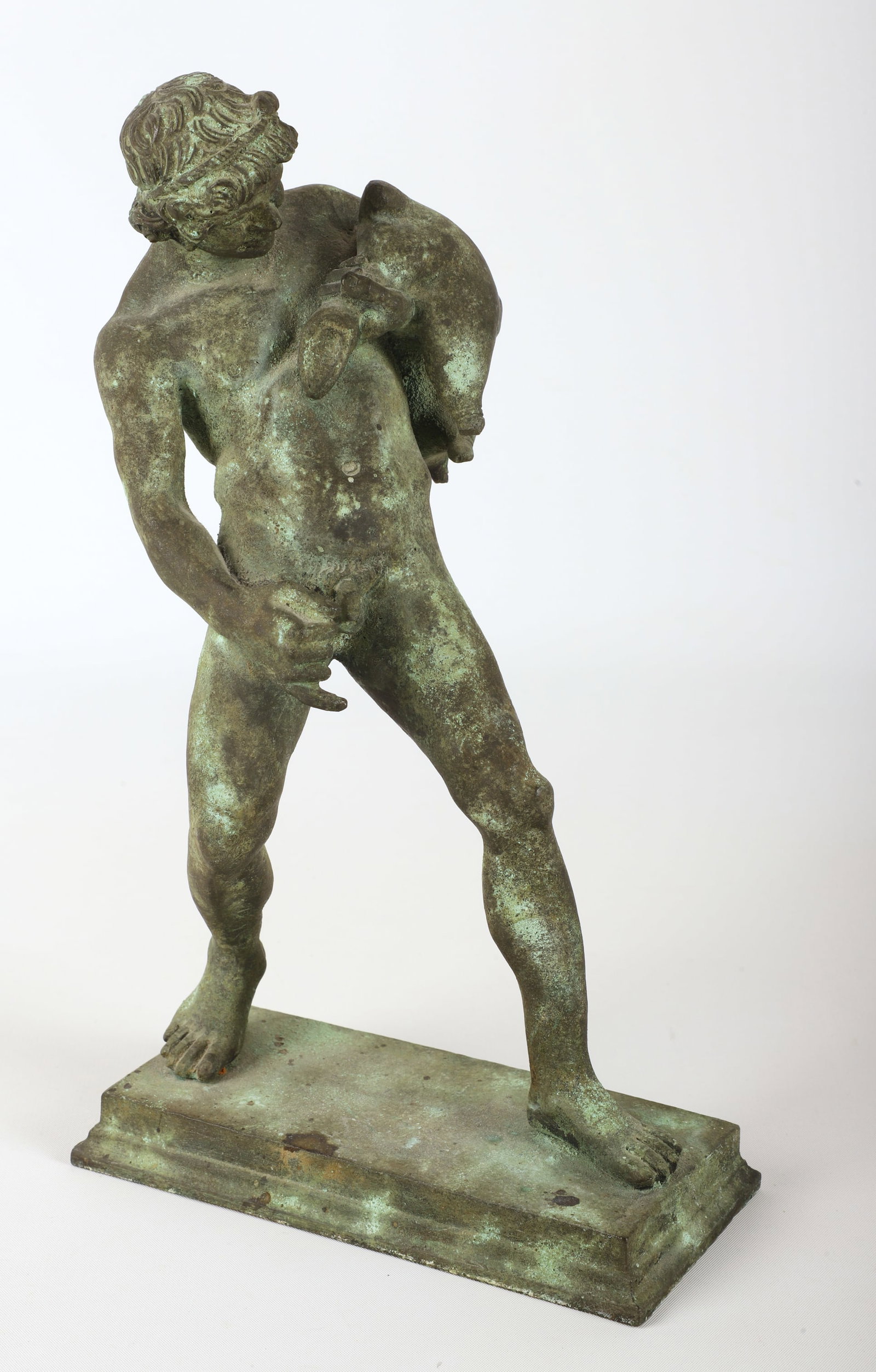 Patinated metal "Satyr with a Wineskin" sculpture: Grand Tour style patinated metal "Satyr with a Wineskin" sculpture, after a sculpture From the House of the Centenary Pompeii, nude male pouring wine from a wineskin, which he clutches under his left 