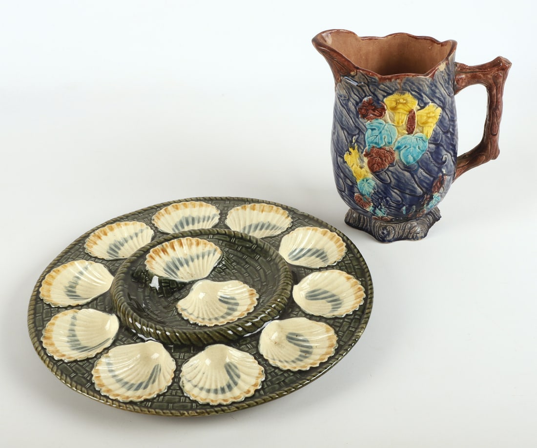 (2) Pieces of majolica: (2) Pieces of majolica, including Longchamp oyster platter impressed "Longchamp" on base (13" dia, chip to base), unmarked faux bois pitcher with floral & leaf decoration (8-1/2" h, possible repair to