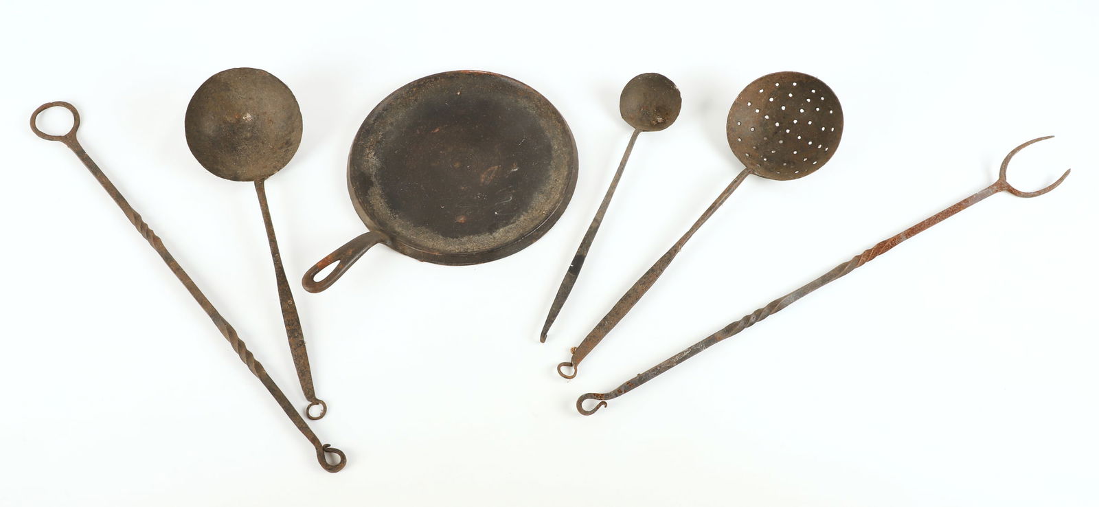 Lot of cast & wrought iron kitchen items: Lot of cast & wrought iron kitchen items, including Wagner Ware Sidney round griddle (10-3/4" dia) & (5) utensils (longest 25")