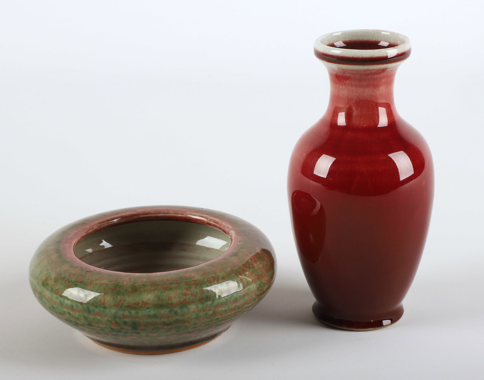 (2) Pieces of Chinese porcelain: (2) Pieces of Chinese porcelain, including oxblood glaze vase with 4-character mark to base (5-3/4" h), unmarked brush washer (4-3/4" dia x 1-7/8" h)
