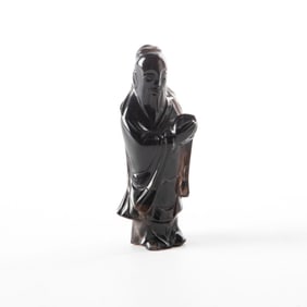 Carved obsidian standing robed figure with peach